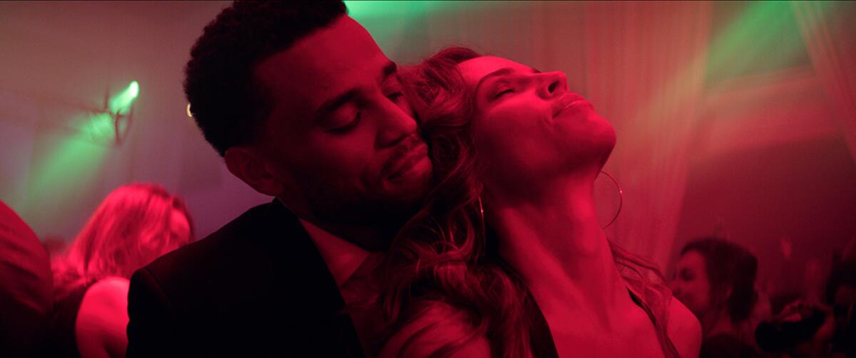 Michael Ealy nuzzles Hilary Swank in the thriller "Fatale."