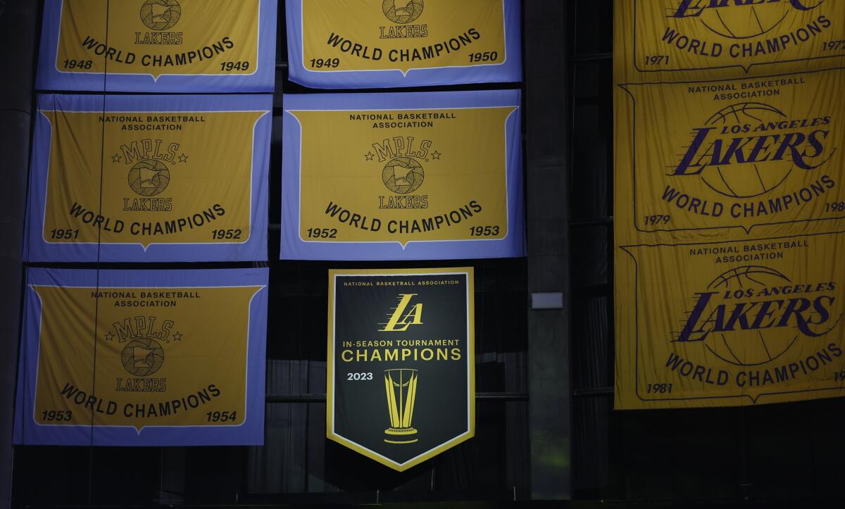The  NBA Cup championship banner is lowered among other banners.
