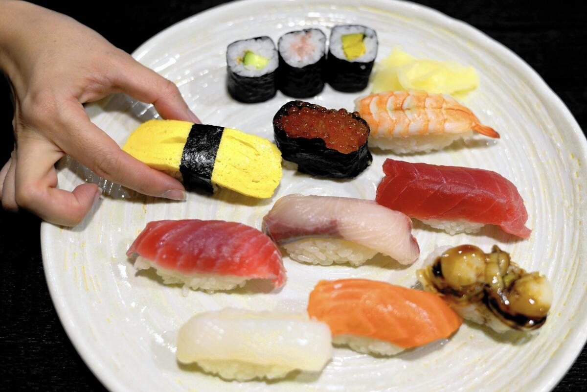 Use your hands, not chopsticks, to pick up nigiri. Chopsticks are for sashimi.