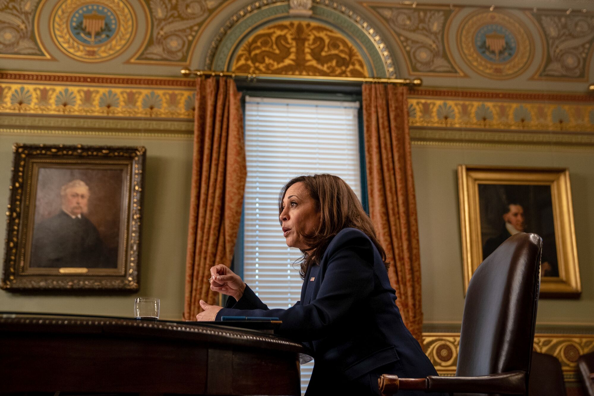 A profile shot of Vice President Kamala Harris seated at a desk