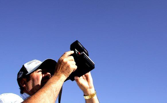 At a recent Our Lady of the Rock gathering in the desert near California City in Kern County, Elaido Chavez takes a Polaroid photo of the sun in hopes of seeing an image of the Virgin Mary. The ceremony takes place on the 13th of every month. About 1,000 people attended the April gathering.