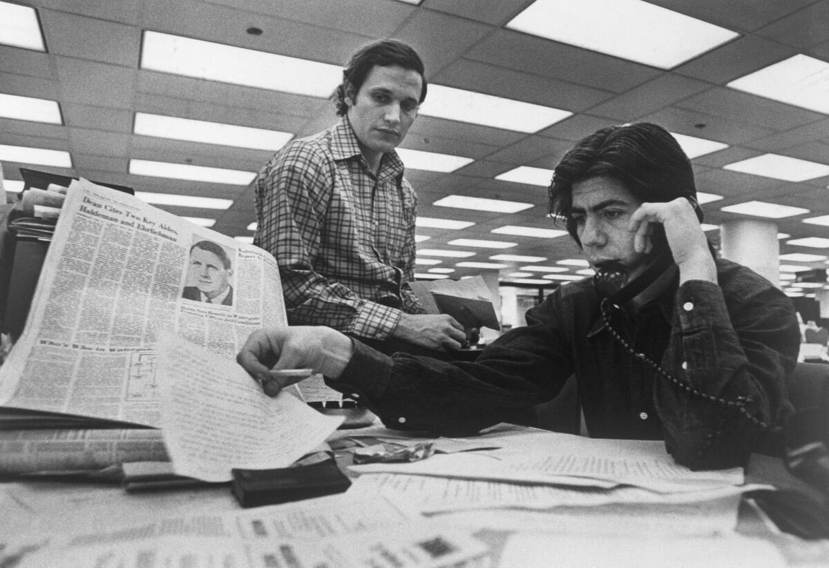 Bob Woodward (left) and Carl Bernstein investigating the Watergate case.