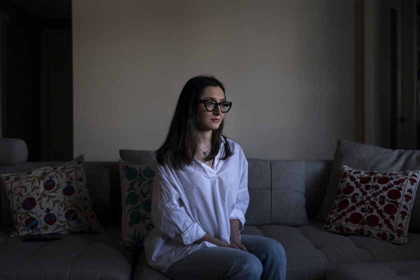 Leili Ghazi, a 22-year-old immigrant from Iran, sits for a photo in Pasadena, Calif., Tuesday, June 21, 2022. Two years ago, Leili Ghazi quit studying biomedical engineering in Iran and seized the chance to travel to the United States to build a new life for herself and her parents. Now, the 22-year-old is separated indefinitely from her family because her father performed military service more than two decades ago for a branch of the Iranian armed forces that the U.S. government has declared a foreign terrorist organization. (AP Photo/Jae C. Hong)