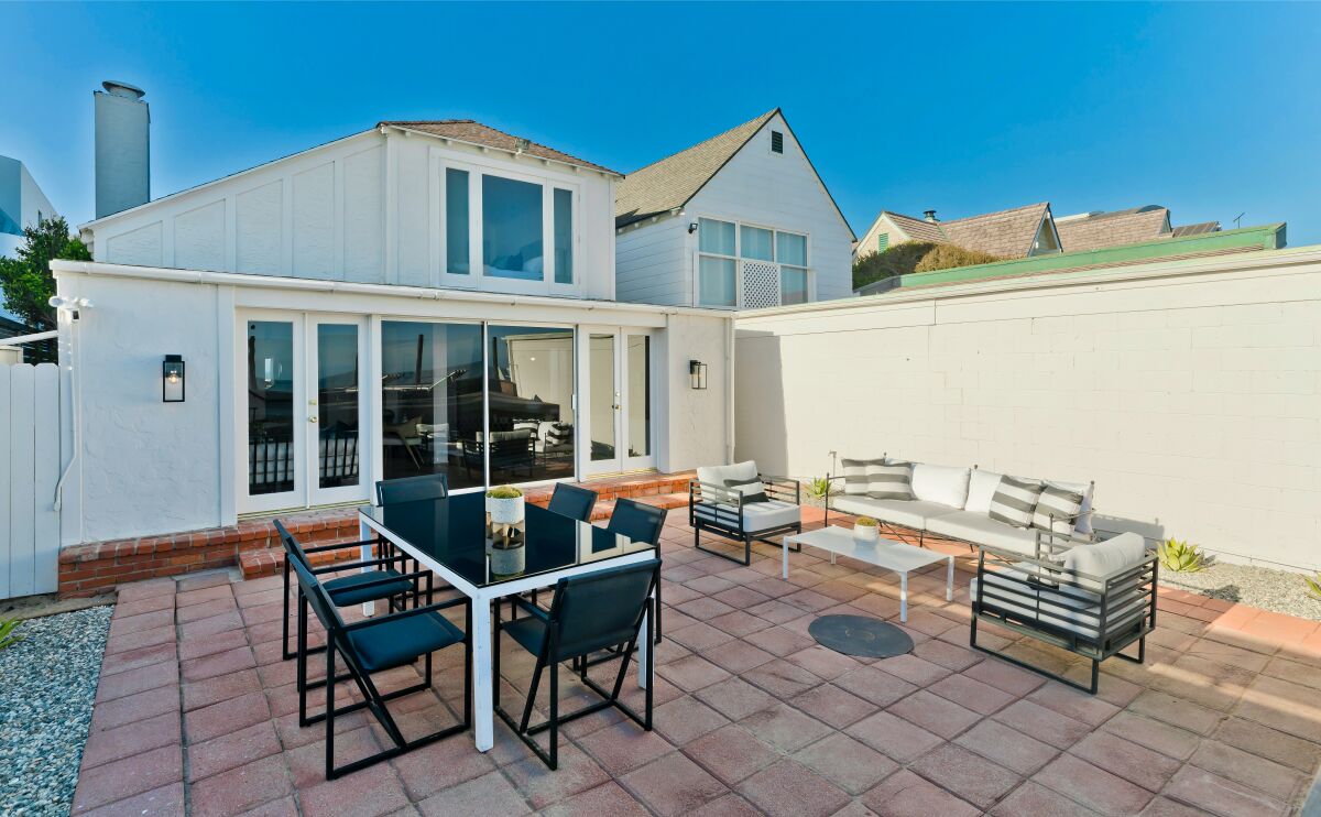 Built in 1930, the coastal home overlooks the ocean from an entertaining terrace and raised wood deck.