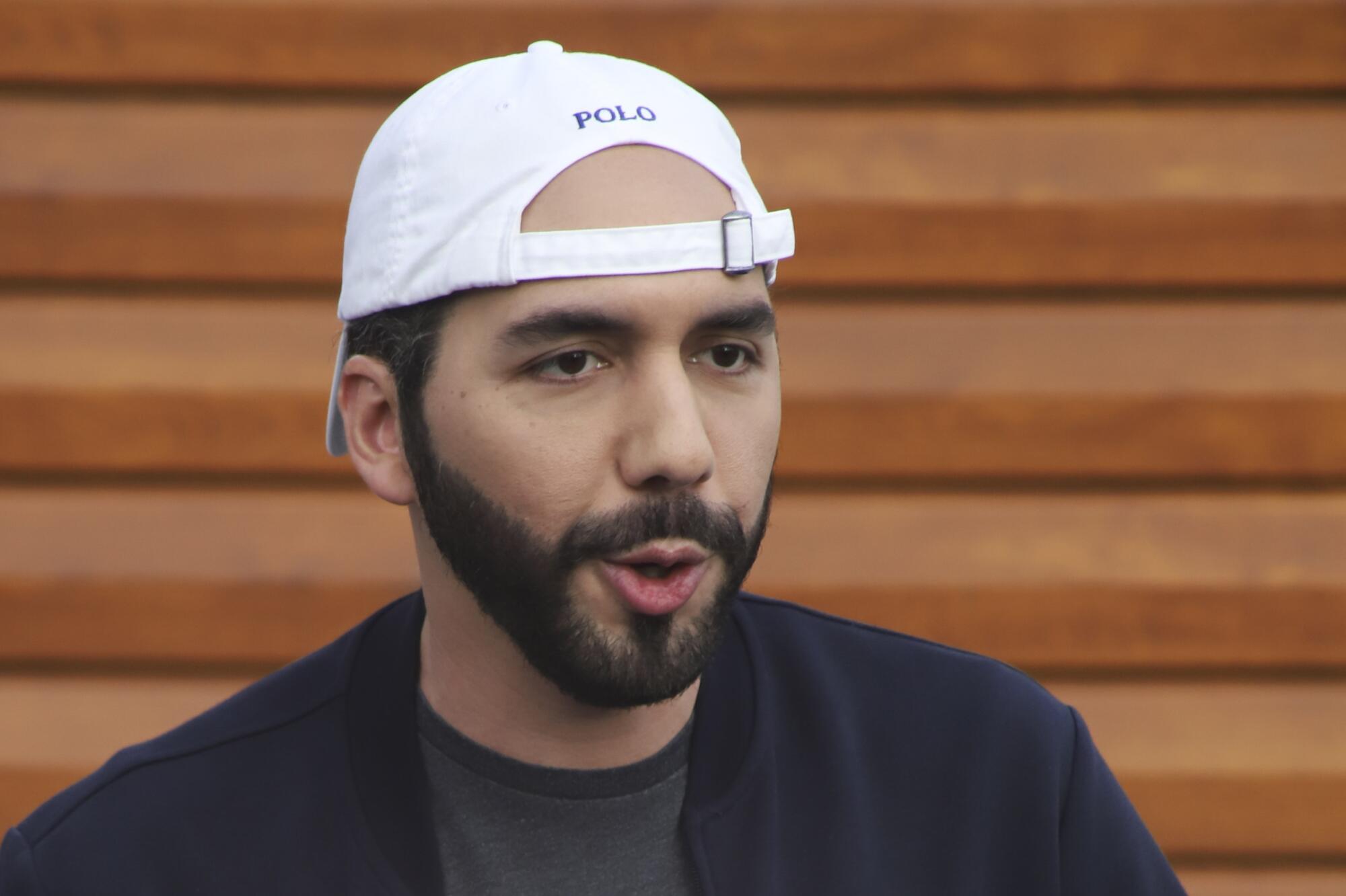 President Nayib Bukele wearing a backward baseball cap 