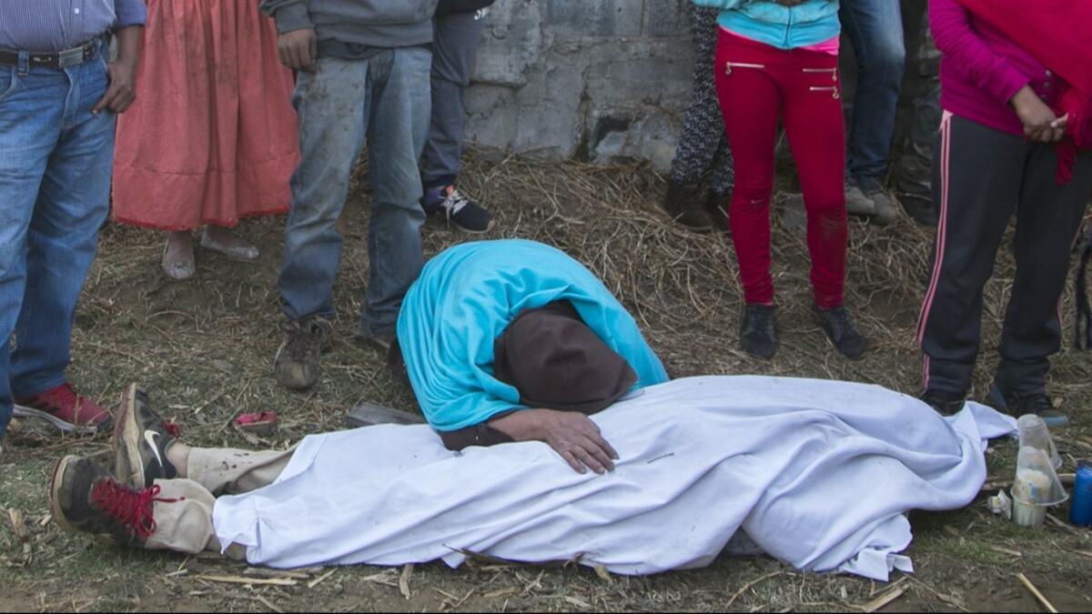 In this April 5, 2017, photo, a woman mourns a person killed during a clash between villagers and state police in Arantepacua, a town in Mexico's Michoacan state.