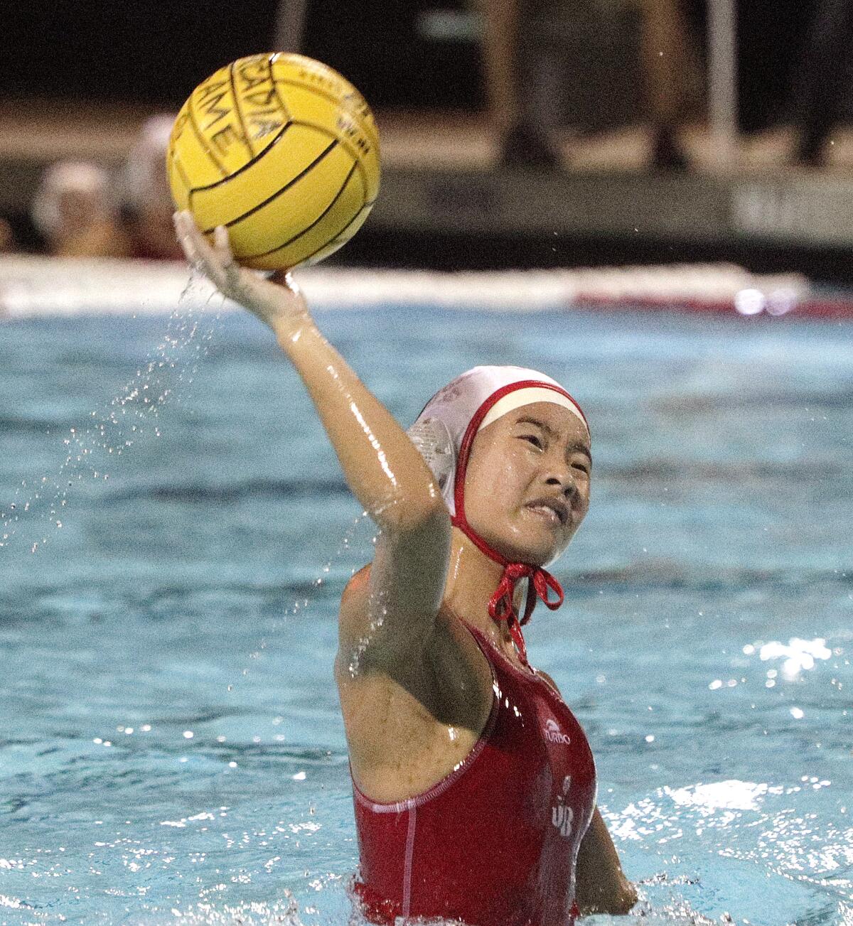 Burroughs' Angelina Lee takes a distant shot on goal that goes over the Arcadia goalies' fingers to score in the Pacific League girls' water polo championship at Arcadia High School on Thursday, February 6, 2020. Arcadia won the match in the second overtime.