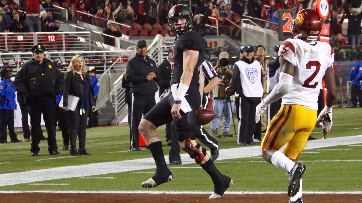 Stanford quarterback Kevin Hogan strolls into the end zone past USC cornerback Adoree' Jackson in the Pac-12 championship at Levi's Stadium.