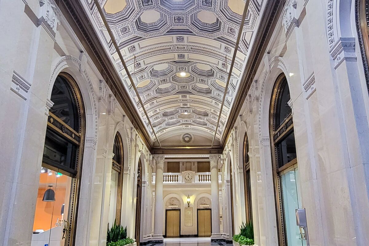 An towering entry hall with a white coffered ceiling. 