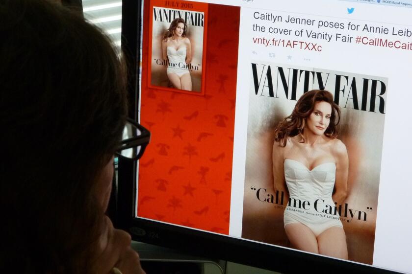 A journalist looks at Vanity Fair's Twitter site about Caitlyn Jenner, who will be featured on the July cover of the magazine.