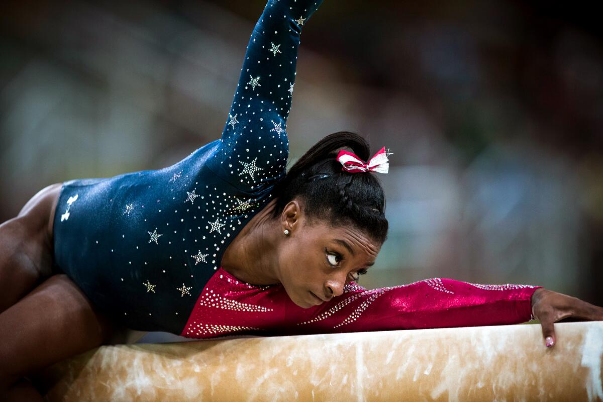 Simone Biles extends one arm on a balance beam and raises the other in "Simone Biles Rising."