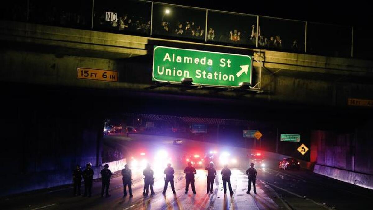 Police block traffic on the 101 Freeway near downtown L.A. as protesters rally against Donald Trump's election as president.