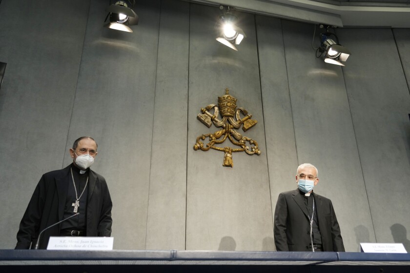 Mons. Filippo Iannone, right, and Mons. Juan Ignacio Arrieta Ochoa de Chinchetru arrive for a press conference to illustrate changes in the Church's Canon law, at the Vatican, Tuesday, June 1, 2021. Pope Francis has changed church law to explicitly criminalize the sexual abuse of adults by priests who abuse their authority and to say that laypeople who hold church office can be sanctioned for similar sex crimes. (AP Photo/Andrew Medichini)
