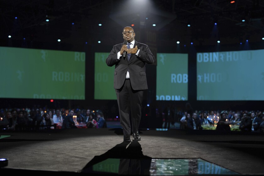 This image provided by Robin Hood shows Robin Hood CEO Richard R. Buery Jr., presiding over the foundation’s annual gala at the Javits Center in New York on Oct. 20, 2021. (Kevin Mazur/Robin Hood via AP)