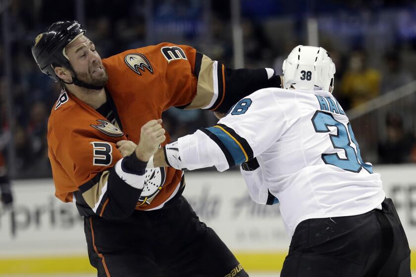 Ducks defenseman Clayton Stoner (3) fights with San Jose Sharks' Micheal Haley during the first period on Oct. 25.