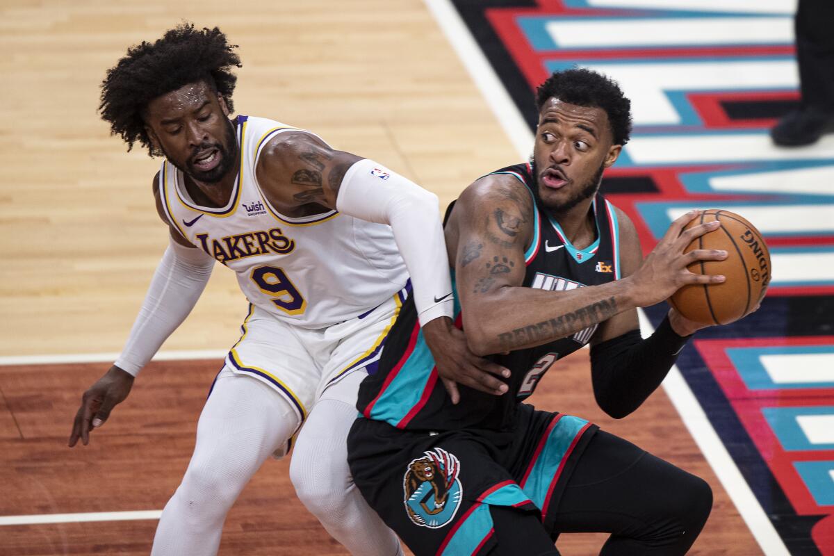 Memphis Grizzlies forward Xavier Tillman keeps the ball from Lakers guard Wesley Matthews.