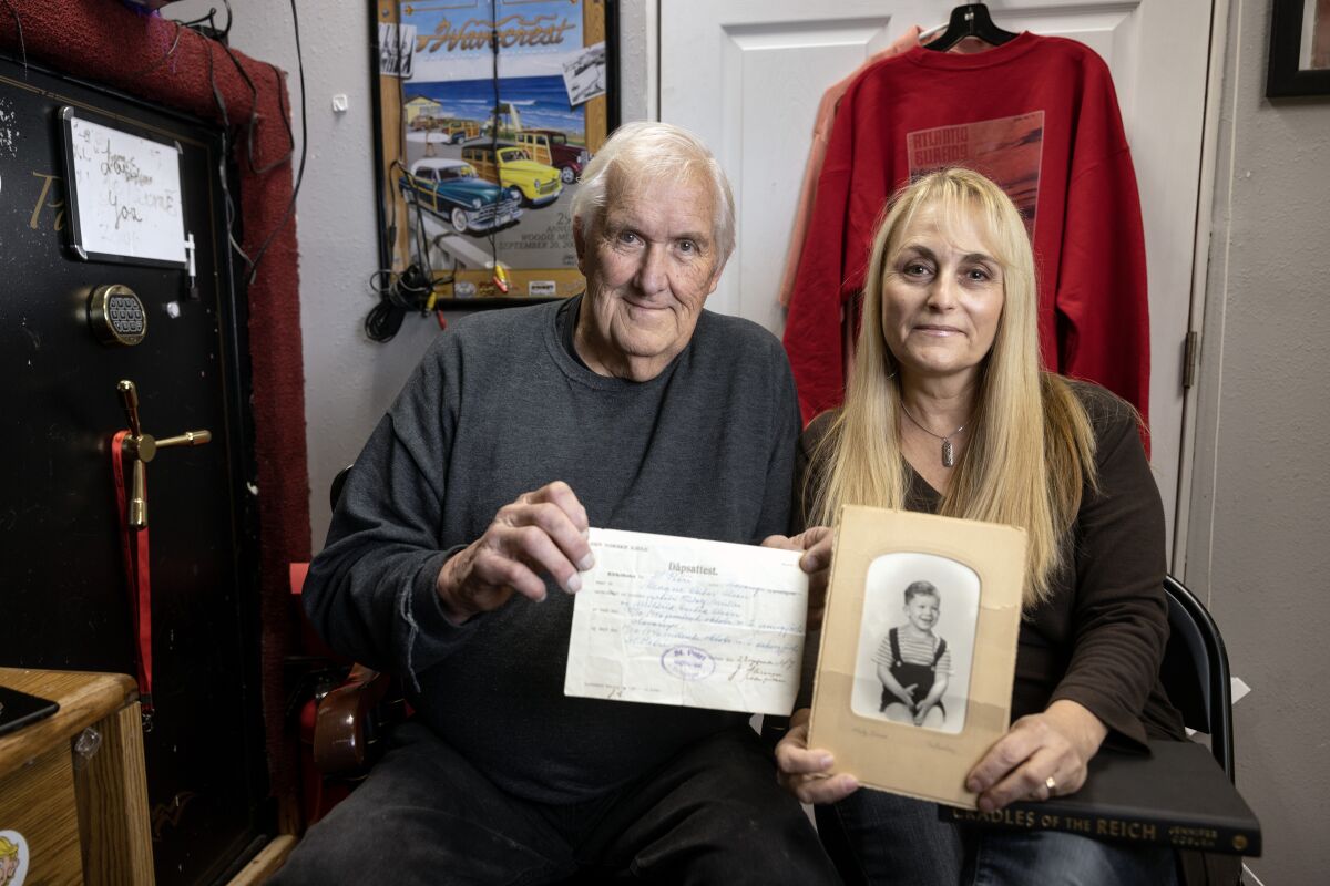 John Gundersen, 77, holds his  birth certificate and Jennifer Coburn holds a picture of Gunderson as a young boy.
