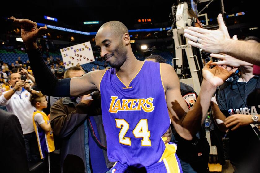 Is Kobe Bryant the greatest player of all time? Where would you rank him? Above, he leaves the court in Minneapolis in December 2014 after passing Michael Jordan on the all-time scoring list.