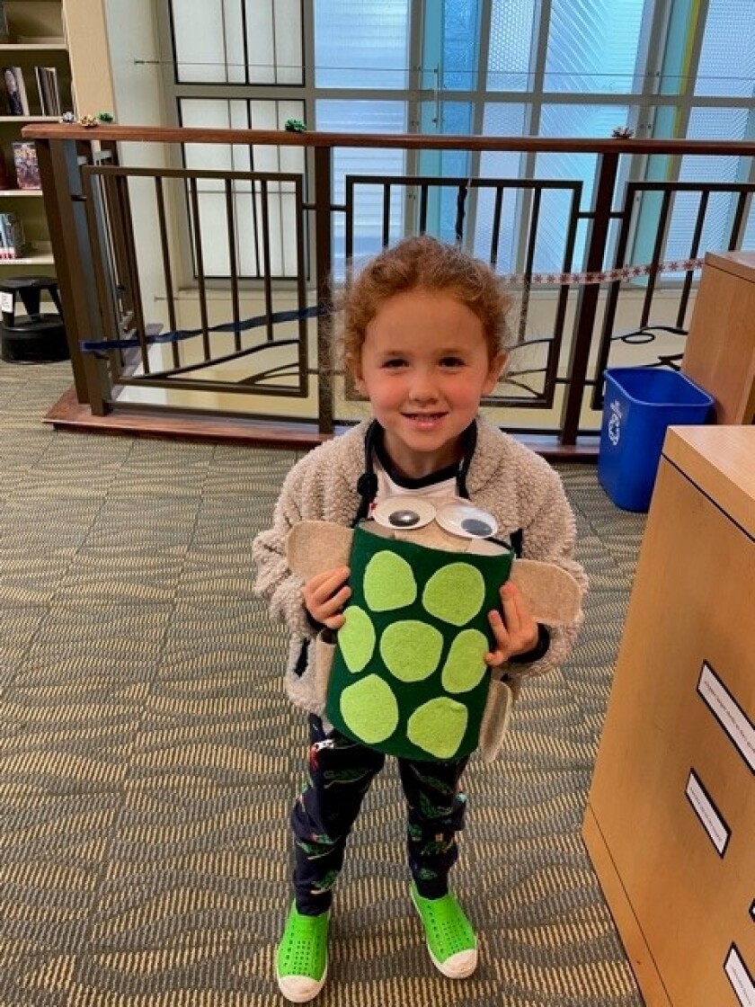 Lillian Lowenthal, 4, is a fan of the La Jolla/Riford Library's not-so-real turtle, Tipster.