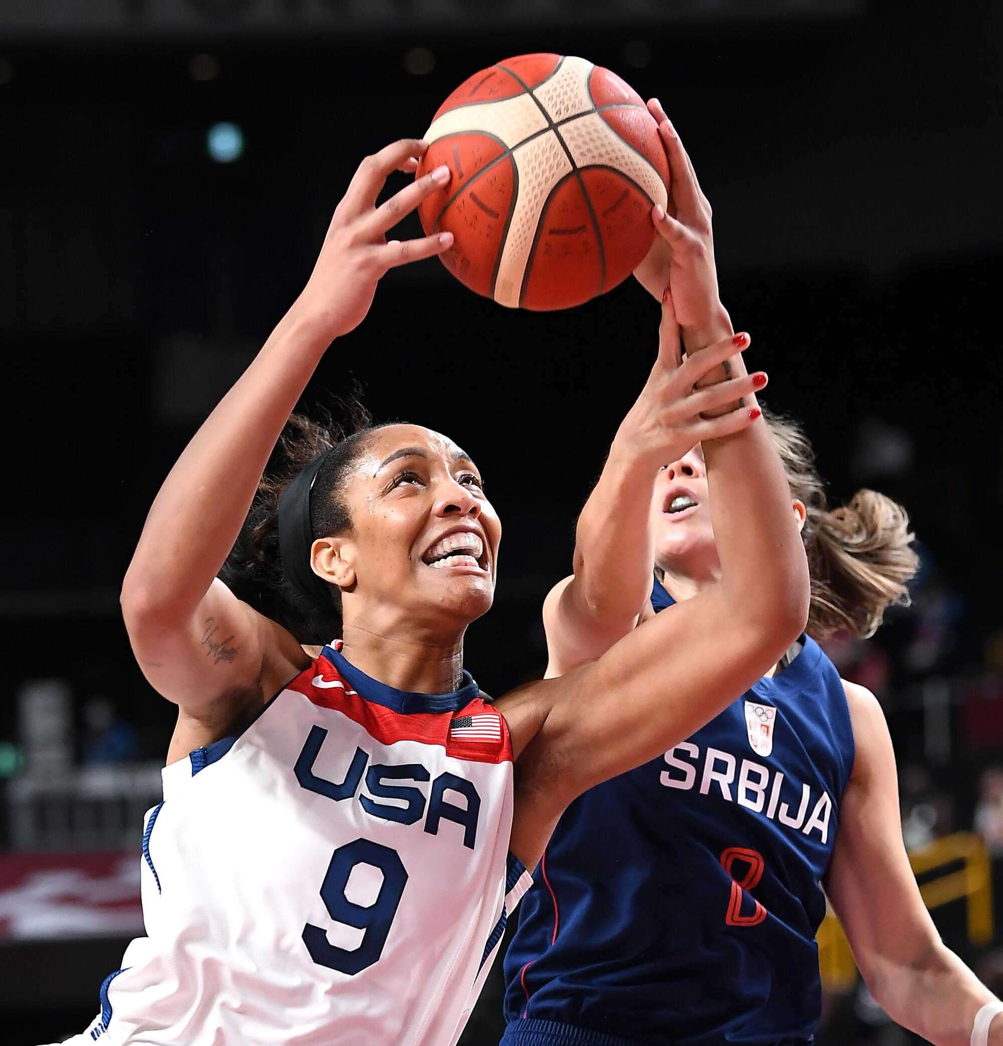 Serbia's Nevena Jovanovic fouls A'ja Wilson during a basketball game at the Tokyo Olympics.