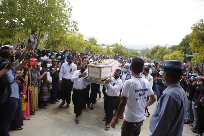 The casket containing the body of Mya Thwet Thwet Khine being carried through the crowds towards the cemetery in Naypyitaw Myanmar, Sunday, Feb. 21, 2021. Mya Thwet Thwet Khine was the first confirmed death among the many thousands who have taken to the streets to protest the Feb. 1 coup that toppled the elected government of Aung San Suu Kyi. The woman was shot on Feb. 9, two days before her 20th birthday, at a protest in the capital Nayptitaw, and died Friday. (AP Photo)