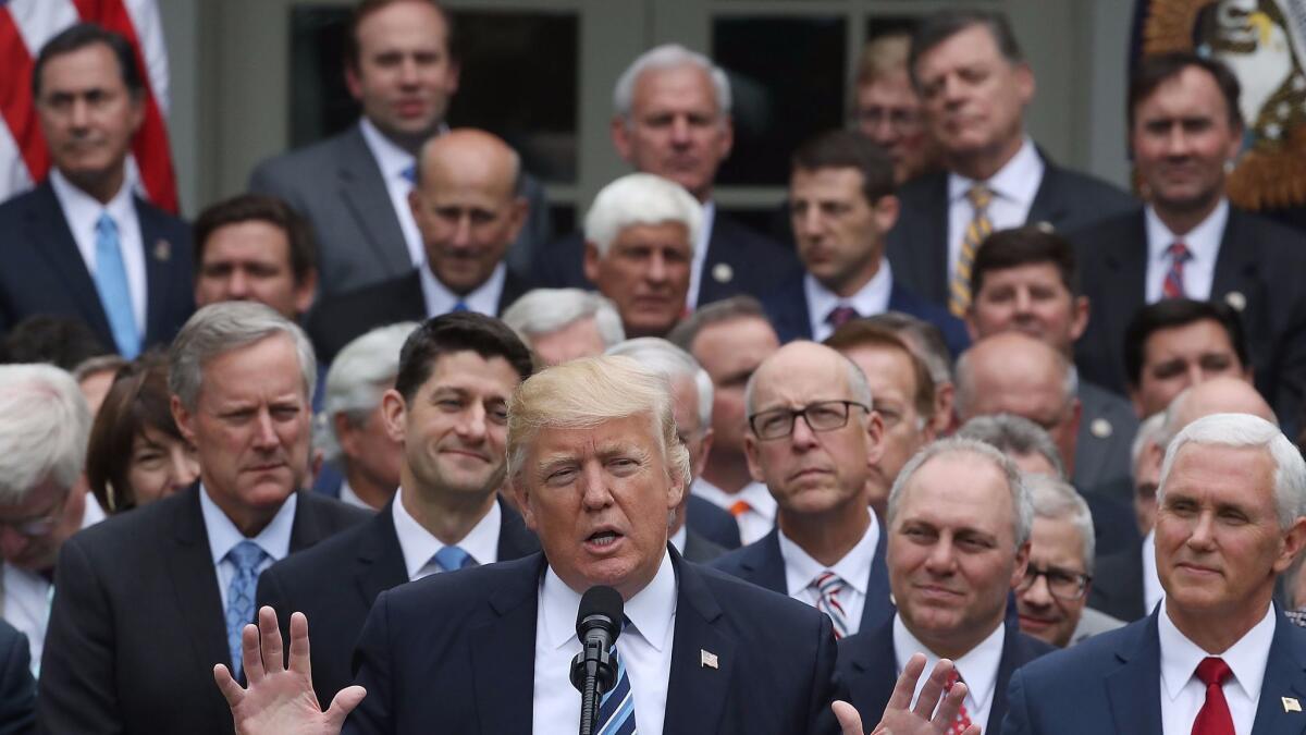 President Trump celebrates with fellow Republicans in the Rose Garden after the House passed legislation to replace the Affordable Care Act.