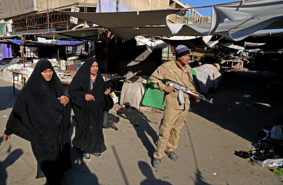 An Iraqi security guard at the site of a bombing in a Christian section of Baghdad on Christmas Day. According to U.N. estimates, more than 8,000 people have been killed in violence this year in Iraq.
