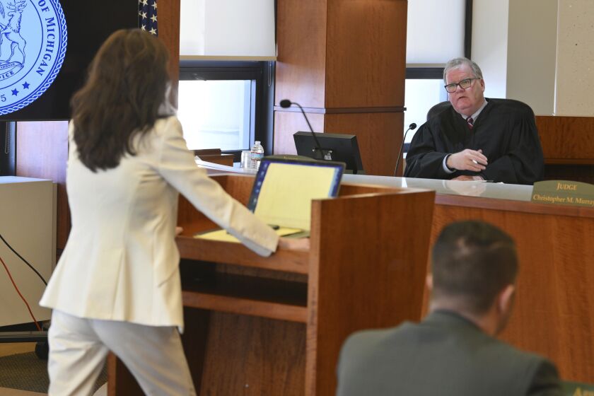 Michigan Court of Appeals Judge Michael Riordan, speaks with attorney Shannon Smith, for Jennifer Crumbley, during a hearing of James and Jennifer Crumbley by the Michigan Court of Appeals, on whether there is enough evidence for the Crumbleys to stand trial for involuntary manslaughter in the Oxford High School shooting by their son Ethan, in Detroit, on Tuesday, March 7, 2023. (Daniel Mears/Detroit News via AP, Pool)