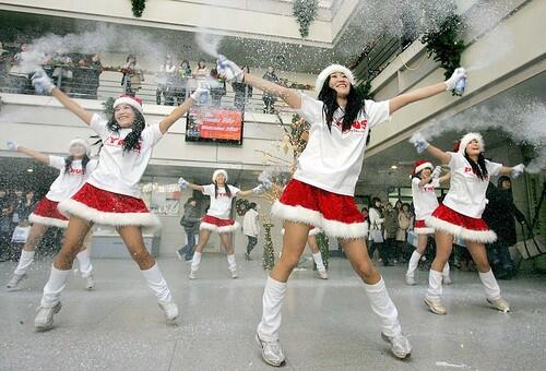 South Korea's Ewha Women's University students dressed in Santa Claus perform during a 'Thanks 2007 Welcome 2008' event to celebrate Christmas in Seoul. Christmas is one of the biggest holidays celebrated in South Korea with Christians forming over half of the population.