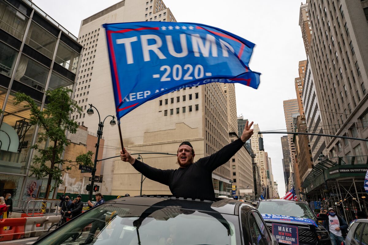  A person participates in a march and rally for President Trump on 5th Avenue on Sunday in New York City.
