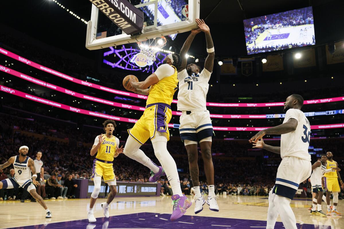 LeBron and Bronny James make historical past in Lakers' season-opening win 2 Anthony Davis drives to the basket against Minnesota center Naz Reid in the second half.