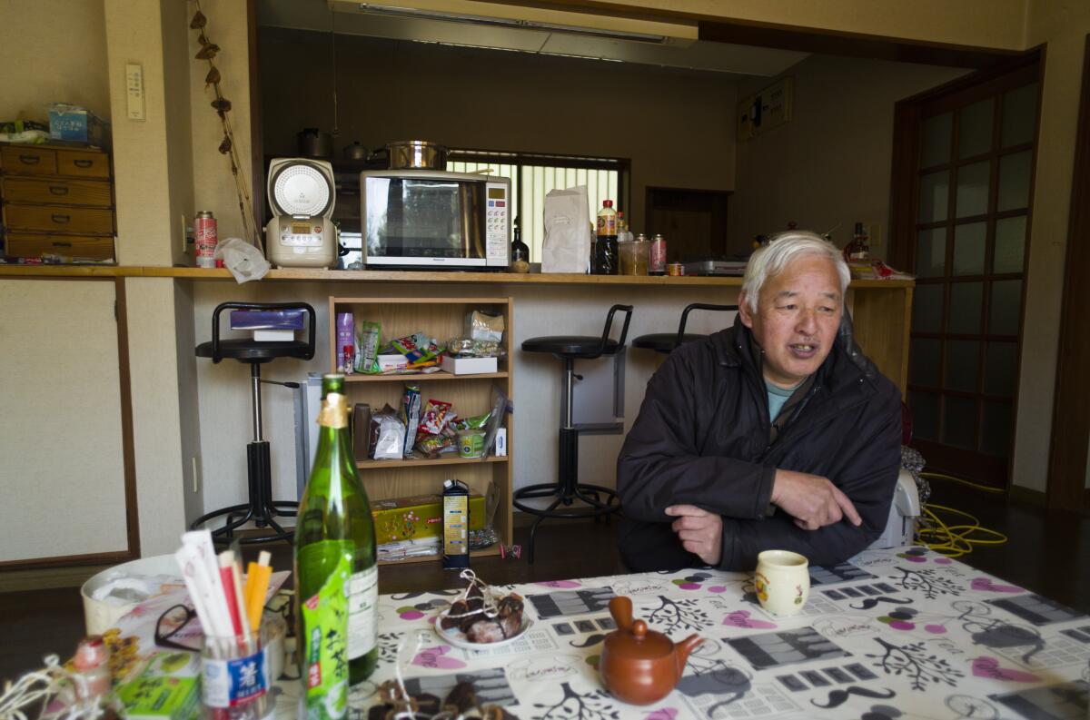 A farmer sits in his home