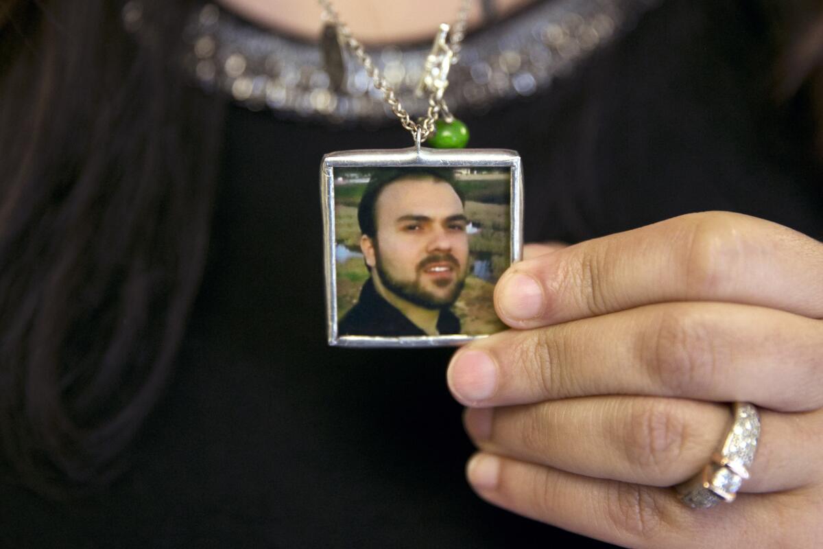 Naghmeh Abedini holds a necklace with a photograph of her husband, Saeed, a Christian pastor.