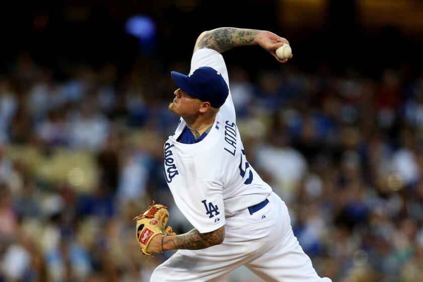 Dodgers starting pitcher Mat Latos delivers a pitch against the Reds in his last start.