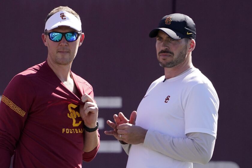 Southern California head coach Lincoln Riley, left, talks with defensive coordinator Alex Grinch.