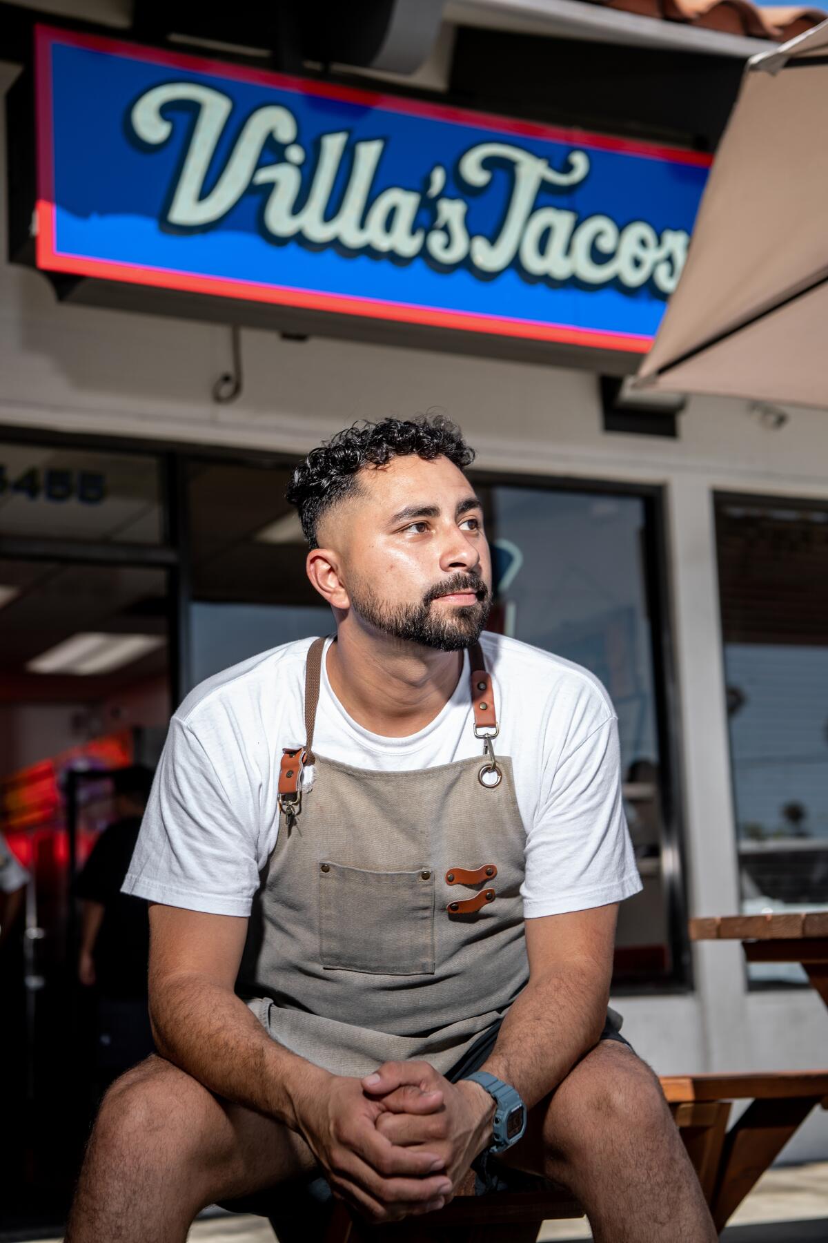 Victor Villa, owner of Villa's Tacos, sits outside of his Highland Park restaurant