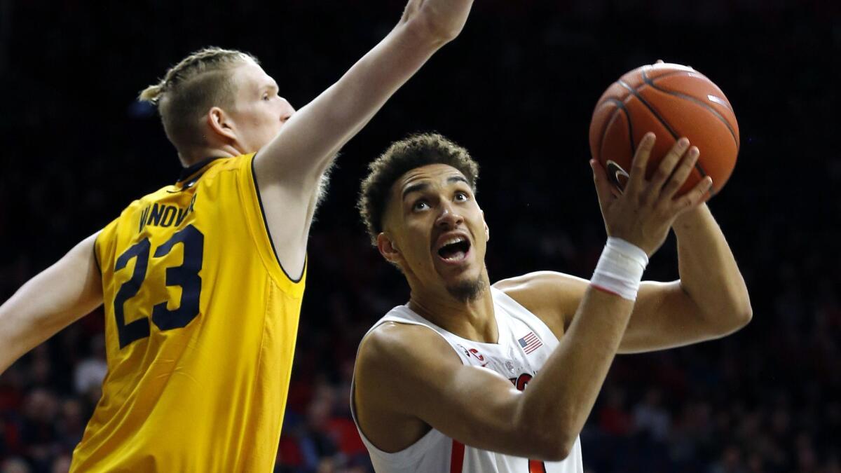 Arizona center Chase Jeter (4) drives on California center Connor Vanover during the second half.