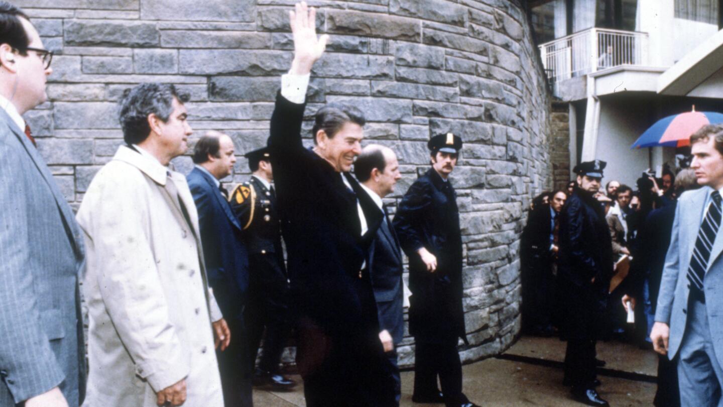 President Reagan waves to the crowd March 30, 1981, outside the Hilton Hotel in Washington.