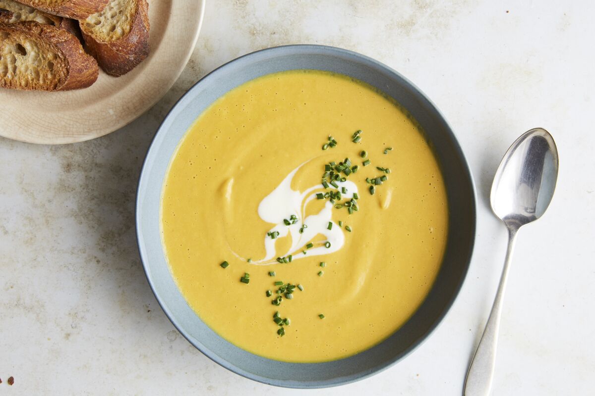 Spicy Peanut and Pumpkin Soup, topped with yogurt and chives.