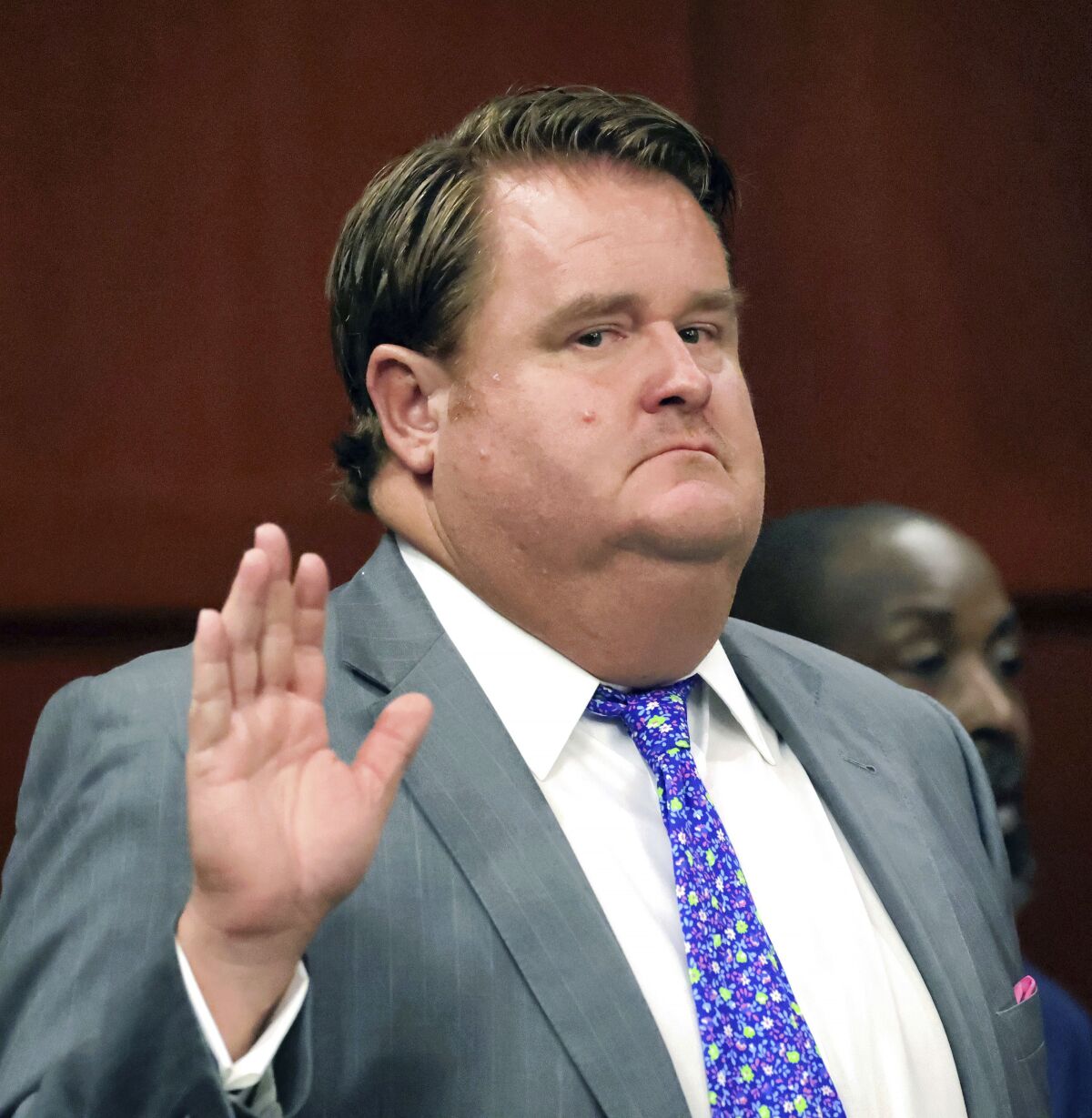 Political consultant Eric Foglesong raises his hand to be sworn-in to testify in an arraignment in Seminole Circuit Court in Sanford, Fla., Tuesday, Aug. 2, 2022. Foglesong pleaded not guilty to felony charges of misreporting contributions to a "ghost candidate" during the campaign for a Florida Senate seat in 2020. (Joe Burbank/Orlando Sentinel via AP)