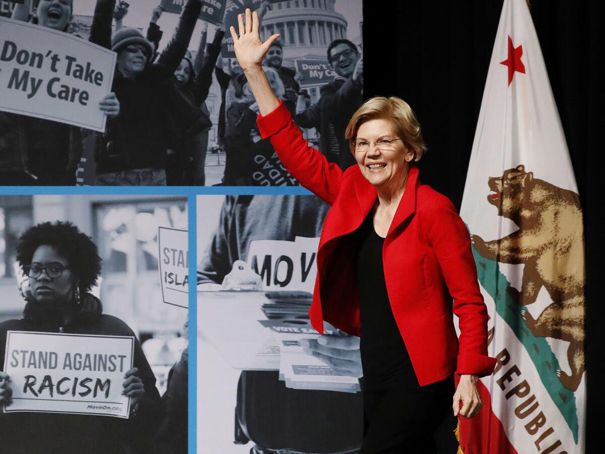 Sen. Elizabeth Warren, shown at a San Francisco forum in June, now leads the Democratic presidential race in California, according to a new poll.