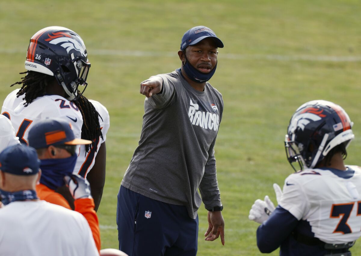 Renaldo Hill directs players on the Denver Broncos during practice.