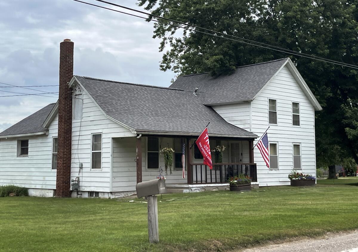 A Trump flag flies outside a home on a rural road in Macomb County, Michigan. 