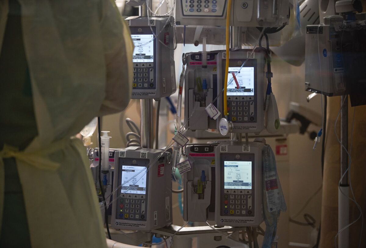 A variety of medical equipment is used on a patient at Scripps Mercy Hospital Chula Vista intensive care unit in 2020.
