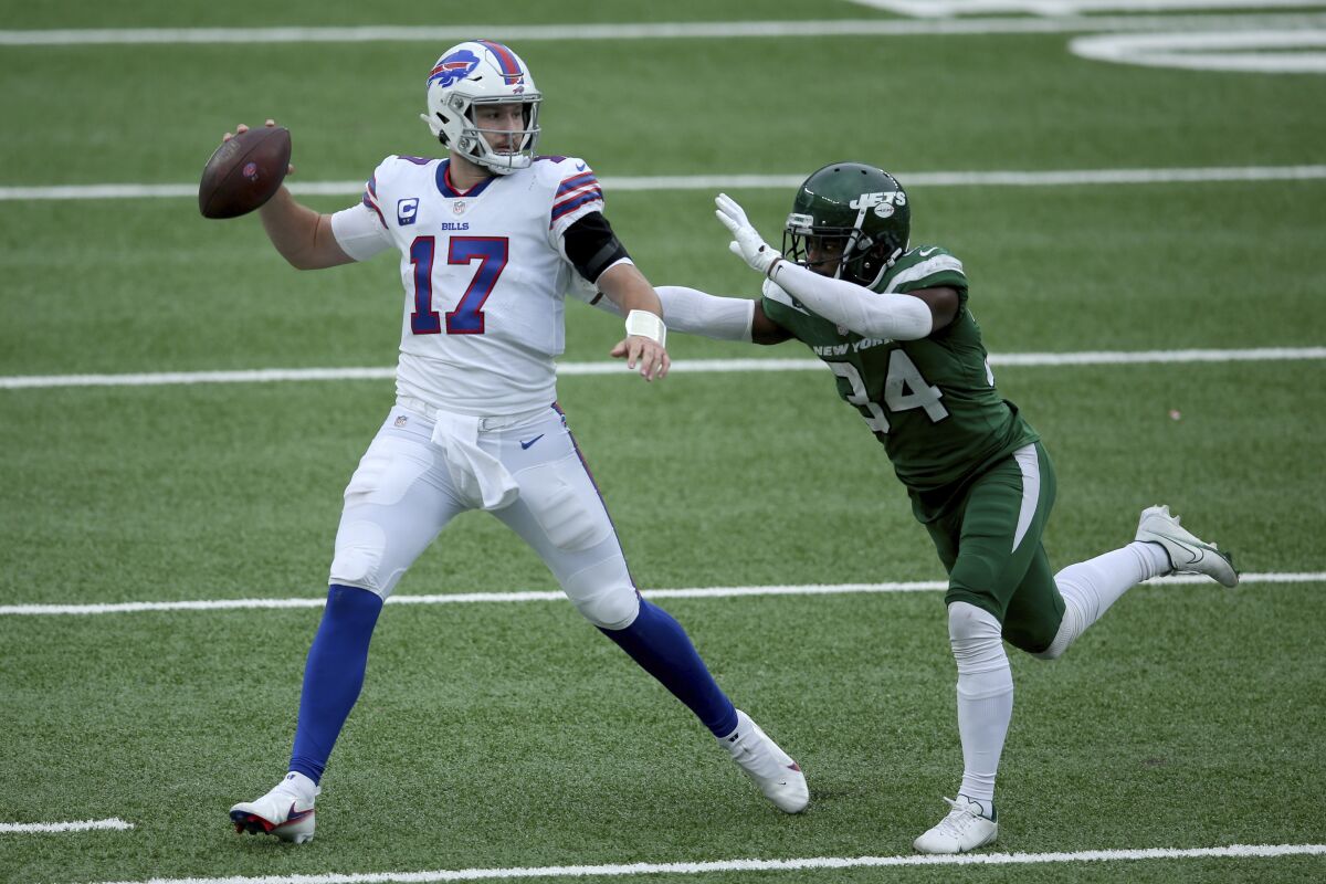 Buffalo Bills quarterback Josh Allen in action against New York Jets cornerback Brian Poole.