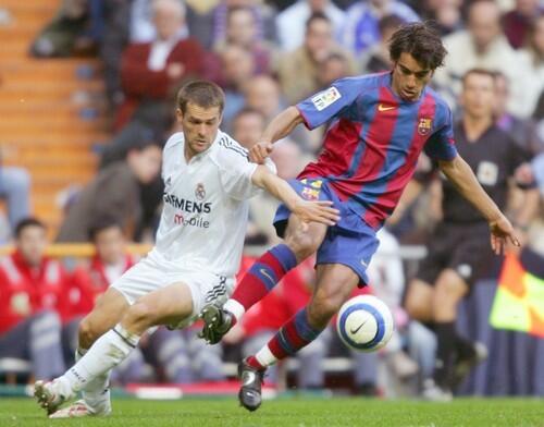Spain's two most famous soccer clubs, Real Madrid and FC Barcelona, share a heated rivalry, known in Spain as 'El Clásico,' that dates back to the Spanish Civil War in the late 1930s. Real Madrid holds a 68-30-60 all-time edge in head-to-head match-ups, though FC Barcelona swept the two matches this year. (Pictured: Real Madrid's Michael Owen, left, vies with Barcelona's Giovani Van Bronckhorst during their Premier League football match in Santiago Bernabeu stadium in Madrid, April 10, 2005.)