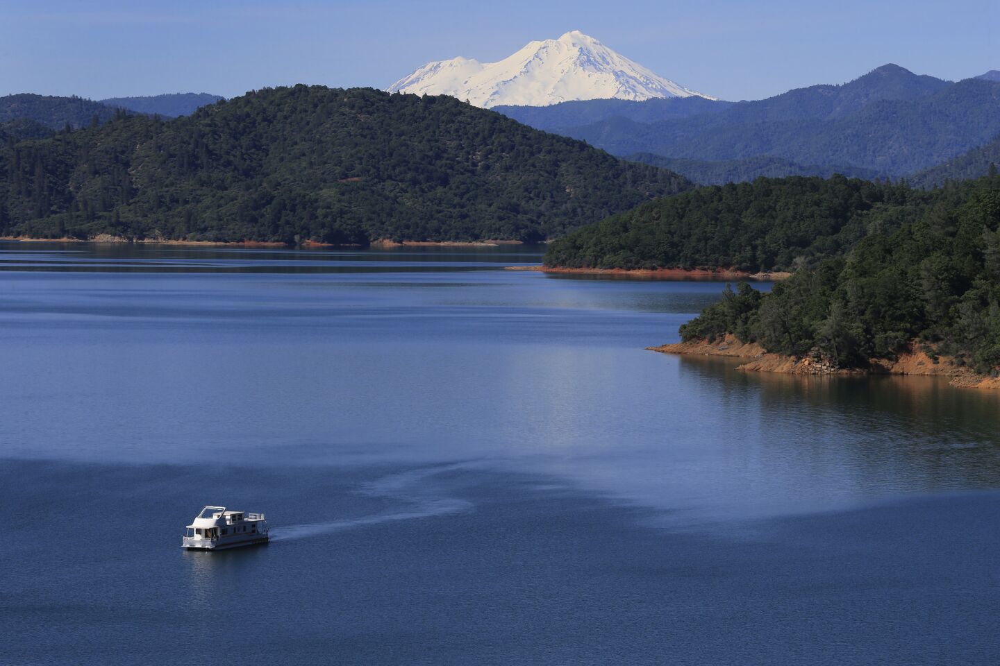 A house boat is on Shasta Lake, which is now more than 90% full thanks to El Nino.
