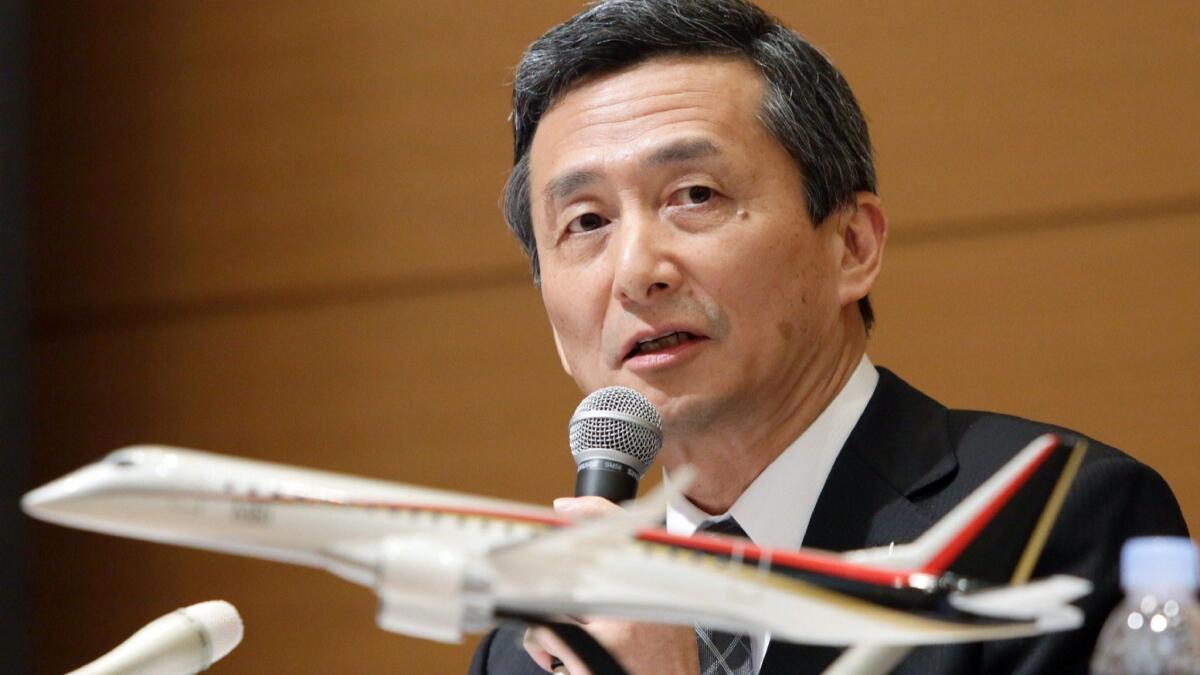 A model of the Mitsubishi Regional Jet set before Hiromichi Morimoto, then president of Mitsubishi Aircraft, at an April 2015 news conference in Japan.