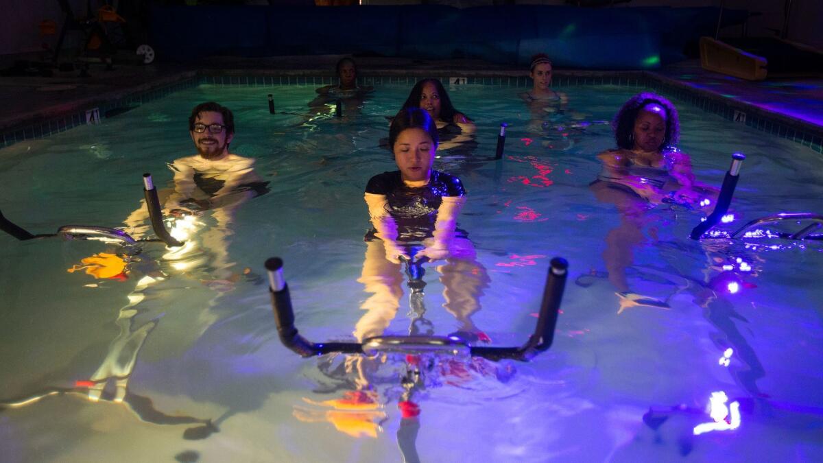 Band work is part of the aqua cycling class. (Gina Ferazzi / Los Angeles Times)