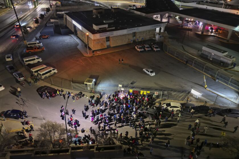 People take part in a vigil for the victims of a fire at an immigration detention center that killed dozens, in Ciudad Juarez, Mexico, Tuesday, March 28, 2023. According to Mexican President Andres Manuel Lopez Obrador, migrants fearing deportation set mattresses ablaze at the center, starting the fire. (AP Photo/Christian Chavez)